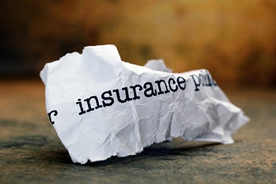 crumpled paper with words insurance policy on it | File A Claim On An Insurance Policy