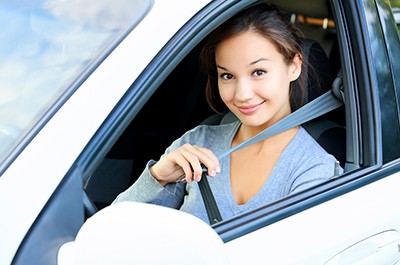 Pretty woman buckling seat belt | The Importance of Seats Belts