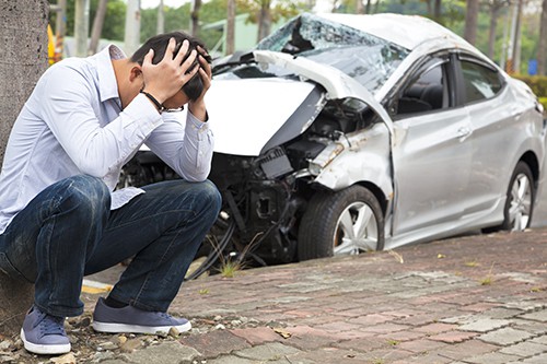 man upset and holding his head after a car accident | Broomfield car accident lawyers