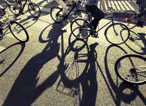 bicyclists and their shadows on the road | Broomfield Bicycle Accident Attorneys