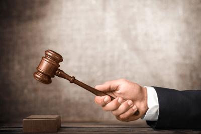 judges hand swinging wooden gavel | Thornton Insurance Dispute Lawyers