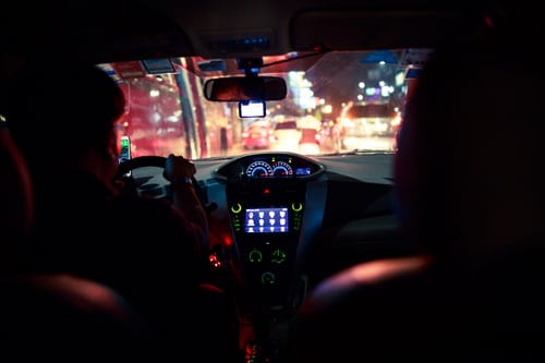 view through the windshield of a cab at night from backseat | After a Ridesharing Accident