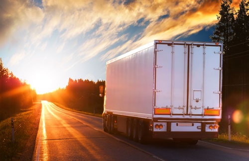 semi truck driving at sunset | Increase in Trucking Accident Fatalities